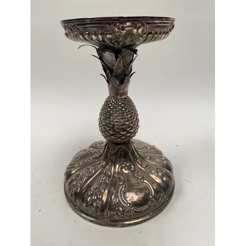 6379 - A Victorian silver pineapple stand. The embossed pineapple holder above a pineapple form stem over a... 