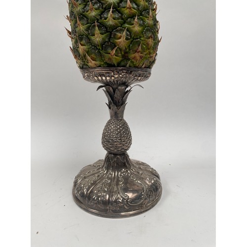 6379 - A Victorian silver pineapple stand. The embossed pineapple holder above a pineapple form stem over a... 