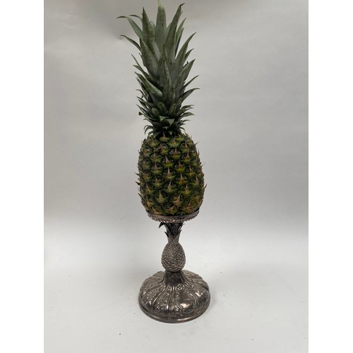 6379 - A Victorian silver pineapple stand. The embossed pineapple holder above a pineapple form stem over a... 