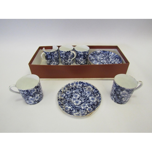 1426 - A Coalport part coffee set, blue flower overall design, gilt rim, six saucers, one a/f and five cans... 