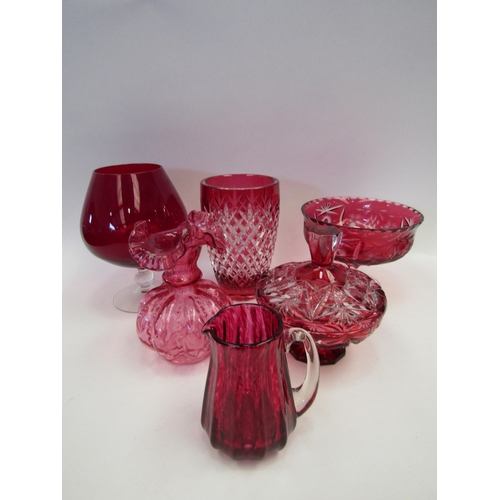 1443 - A quantity of cranberry glass ware including vases