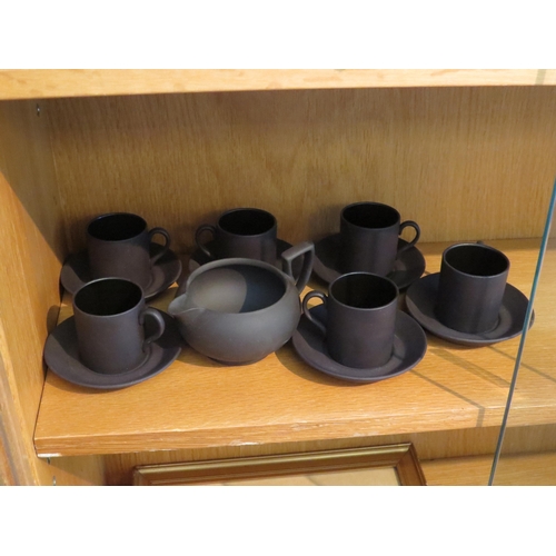 1113 - A set of six Wedgwood basalt coffee cans and saucers and matching creamer