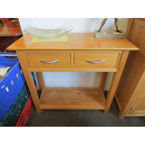 1127 - A natural oak side table with two drawers over an under-shelf united by square leg supports, 77cm ta... 