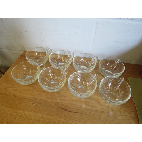 1129 - Eight French moulded clear glass coffee cups