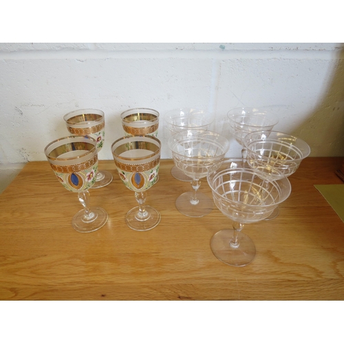 1133 - Five cut glass champagne glasses and four Murano wine glasses with painted enamel flowers, gilt embe... 