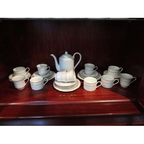 1179 - A quantity of tea and coffee wares, teapot, plates, cups (coffee and tea), white ground gilt bands (... 