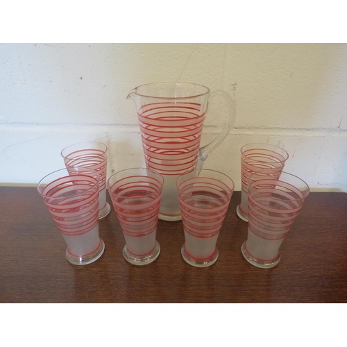 1199 - A 1940's lemonade set with opaque and red bands, jug and six glasses