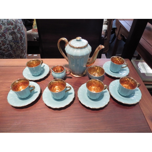 1209 - A Wade six place coffee set, turquoise ground, gilt embellishment gilt interiors