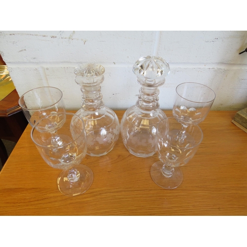 1260 - A pair of Georgian ring neck decanters etched with fruiting vine, associated stoppers (chips to both... 