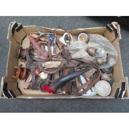 1312 - A box of mixed bygones including fishing reels and leather luggage straps etc.