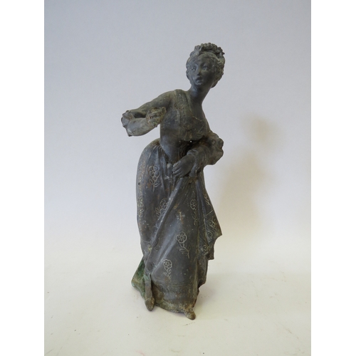 1326 - A 19th Century lead figurine of a women in dress, 20cm high, hand a/f