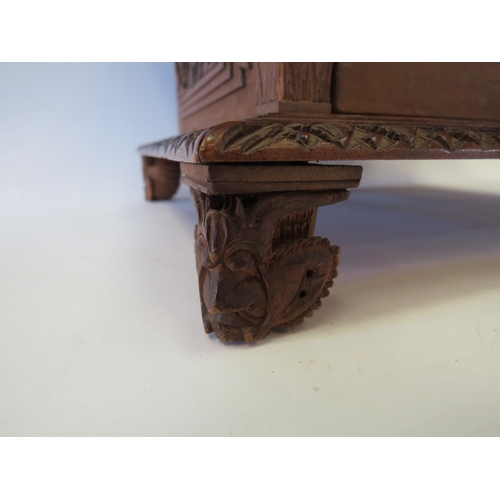 1328 - A Victorian carved Oriental jewellery box, velvet lined interior, one foot missing