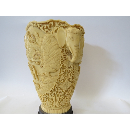 1335 - A resin vase, heavily embossed with Oriental figures in landscape, elephant handles, 31cm tall