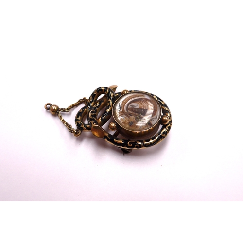 6403 - A Victorian gold memoriam pendant/brooch with black enamel decoration, hair panel decoration to fron... 