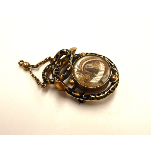 6403 - A Victorian gold memoriam pendant/brooch with black enamel decoration, hair panel decoration to fron... 