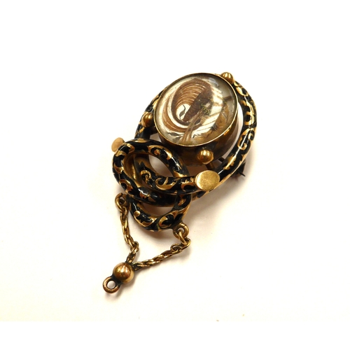 6403 - A Victorian gold memoriam pendant/brooch with black enamel decoration, hair panel decoration to fron... 