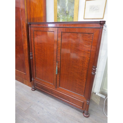 2094 - A 19th Century mahogany two door house keepers cupboard, pillar detail, sliding trays and drawers to... 