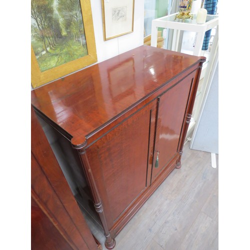 2094 - A 19th Century mahogany two door house keepers cupboard, pillar detail, sliding trays and drawers to... 