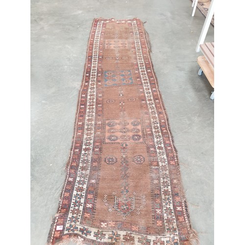 2296 - A heavily worn red and brown runner rug 89 x 330cm