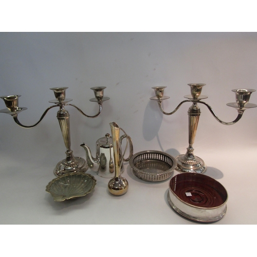 1594 - A collection of silver plate including a pair of candelabra and two wine bottle coasters (7)