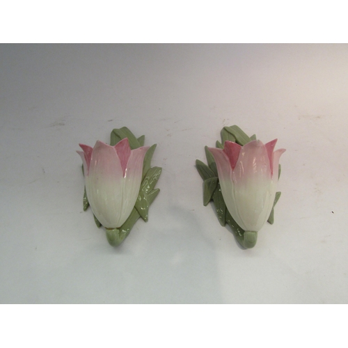 1612 - A pair of Grainger & Co. Worcester wall pockets as pink and white tulips, one A/F, 15cm tall