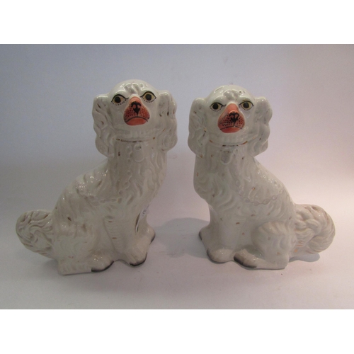 1615 - A pair of Staffordshire white spaniel figures, 32cm high