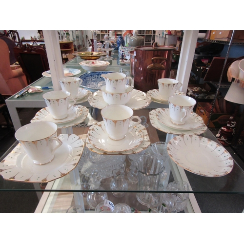 1654 - A Radfords Crown china part tea set, white ground green dot design with gilt embellishment