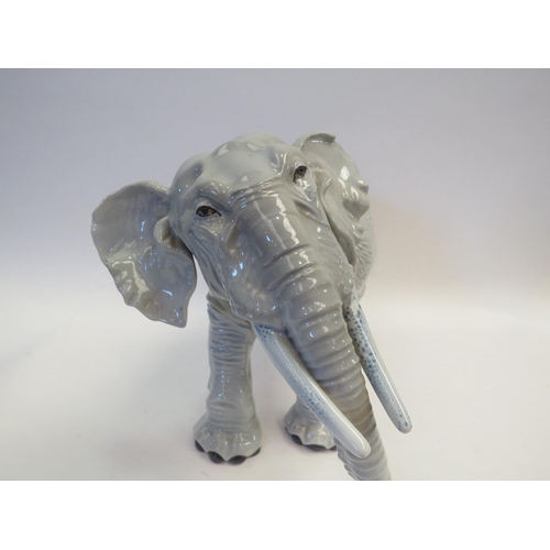 1102 - A large Copenhagen style porcelain elephant, 21.5cm tall