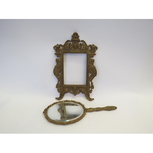 1344 - A gilt brass classical picture frame together with a similar hand mirror (2)