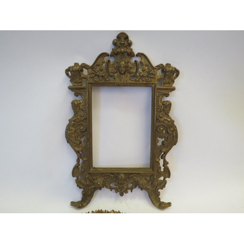 1344 - A gilt brass classical picture frame together with a similar hand mirror (2)