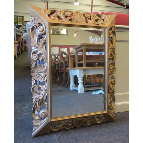 1361 - An 18th Century style cushion mirror, pierced and scrolled foliage, bevelled glass, 82cm high