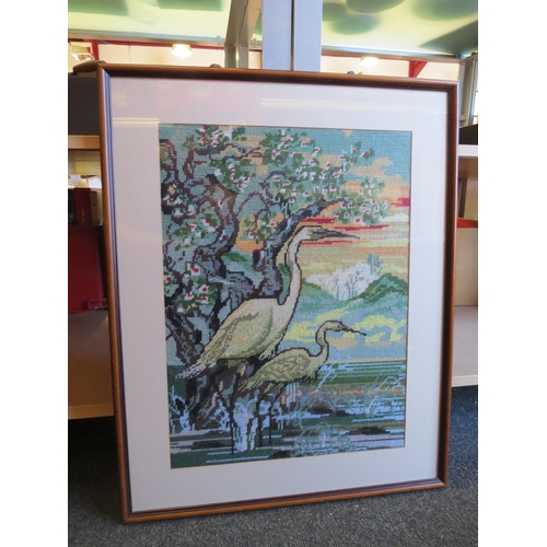 1363 - A large tapestry depicting two herons, framed and glazed, 49cm x 36cm image size