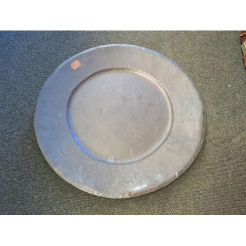 1376 - A hand beaten copper charger of circular form, 50cm diameter