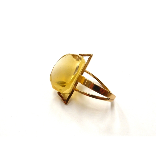 6336 - MARGARET DE PATTA: (1903-1964) An abstract 14k gold ring set with a large three sided facet cut citr... 