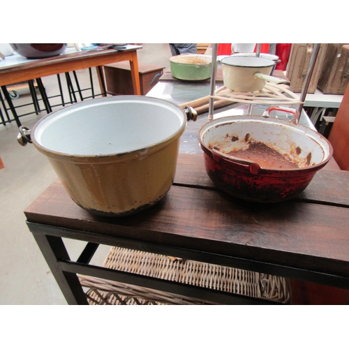 2054 - Two enamel cooking pots, yellow and red