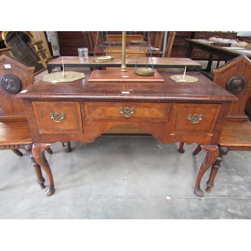 2097 - A Queen Anne style walnut dressing table, the triptech mirror back over a three drawer frieze to cab... 