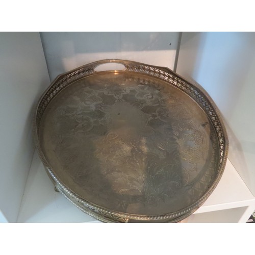 1043 - A plated tray of oval form, with pierced gallery and engraved vacant cartouche (45.5x32cm). An EPNS ... 