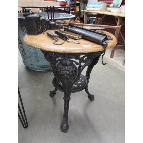 2023 - A mahogany top cast iron based pub table