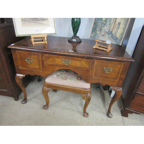 2097 - A Queen Anne style walnut dressing table, the triptech mirror back over a three drawer frieze to cab... 