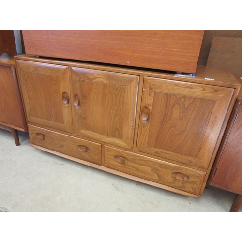 2339 - An Ercol elm three door, two drawer sideboard