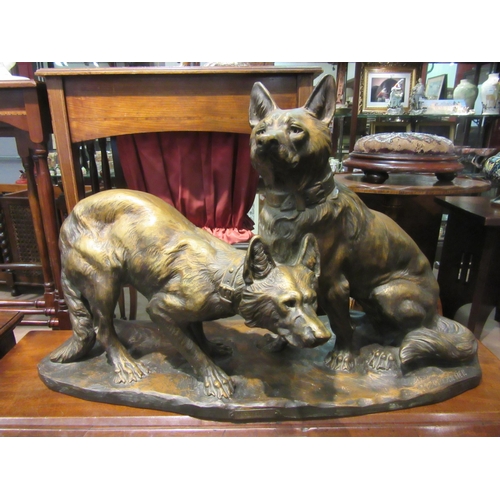 4009 - A painted terracotta figural group of two dogs entitled 