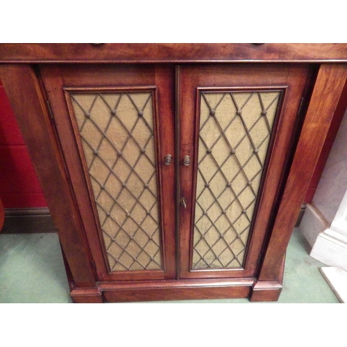 4046 - A Regency flame mahogany side cabinet with canted sides, the single drawer over two lattice brass, c... 