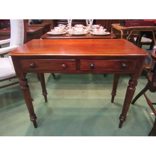 4067 - A late Victorian mahogany side table, the round corner top over two frieze drawers on turned and tap... 