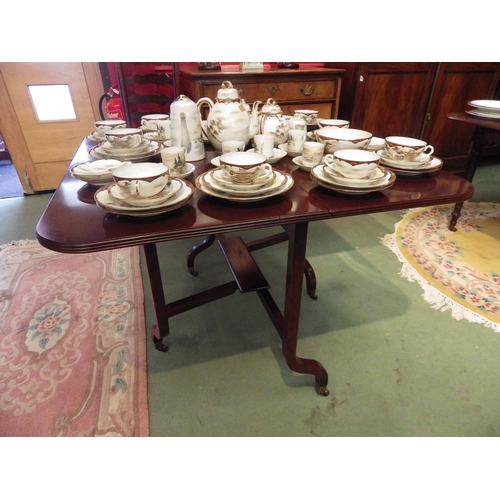 4070 - A George III style mahogany Sutherland table, the rising leaves over shaped legs and brass cup casto... 