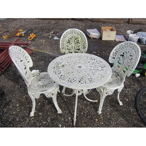 3557 - A cast alloy garden table with three chairs