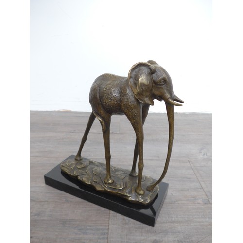 7130 - An abstract bronze figure of an Elephant after Dali. Set on a marble plinth base. 34cm high