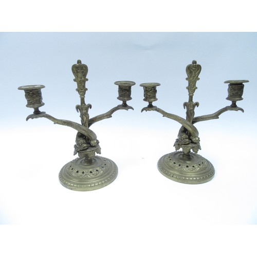 6252 - A pair of Victorian twin sconce candlesticks of dolphin design with pierced circular bases,  25.5cm ... 