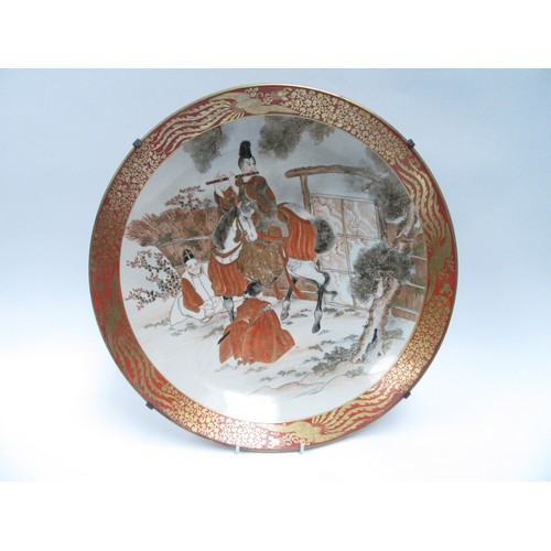 6251 - A 19th Century Japanese Kutani large Oriental shallow form dish depicting gentleman on horse playing... 