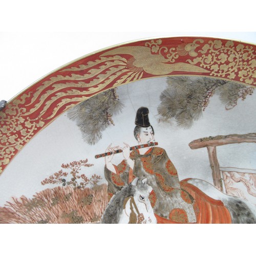 6251 - A 19th Century Japanese Kutani large Oriental shallow form dish depicting gentleman on horse playing... 