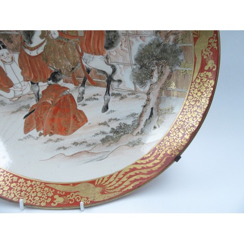 6251 - A 19th Century Japanese Kutani large Oriental shallow form dish depicting gentleman on horse playing... 